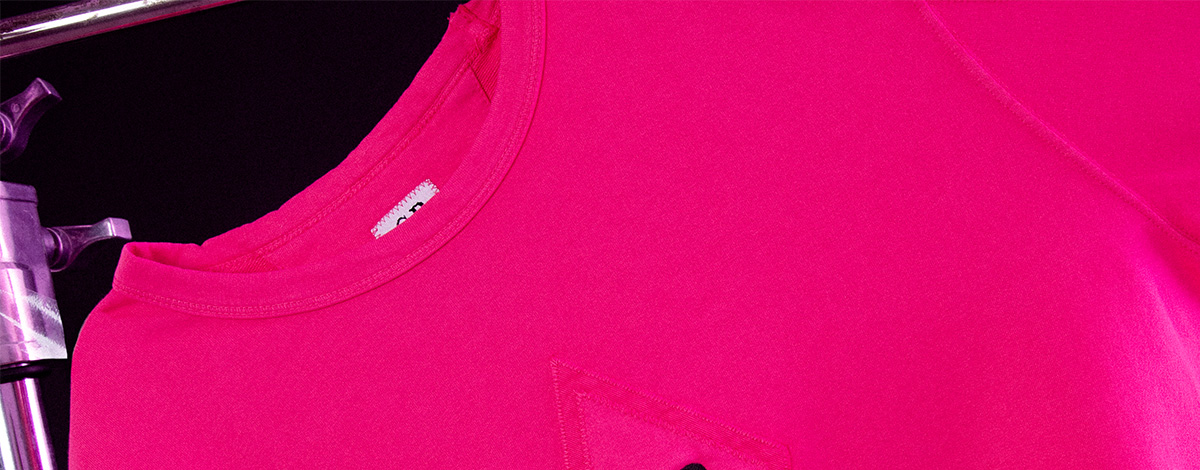 A close-up still life of the black C.P Company embroidered logo on the front of the FLANNELS X C.P. Company exclusive pink sweatshirt
