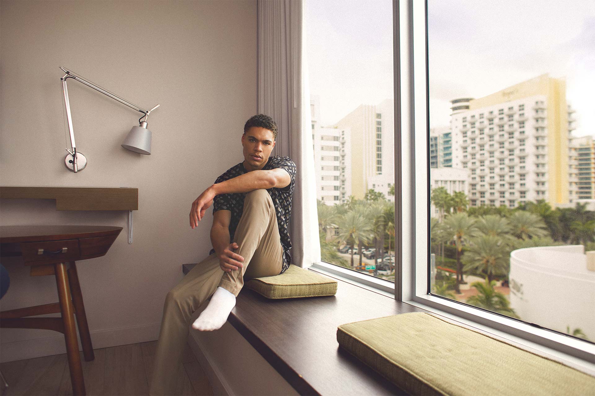 Brian Whittaker sitting on bench in hotel room