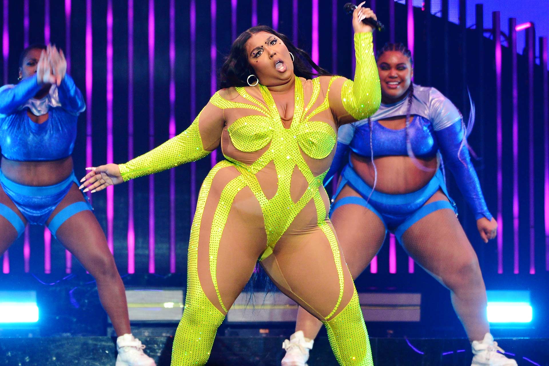 Lizzo performing in a Mugler body suit