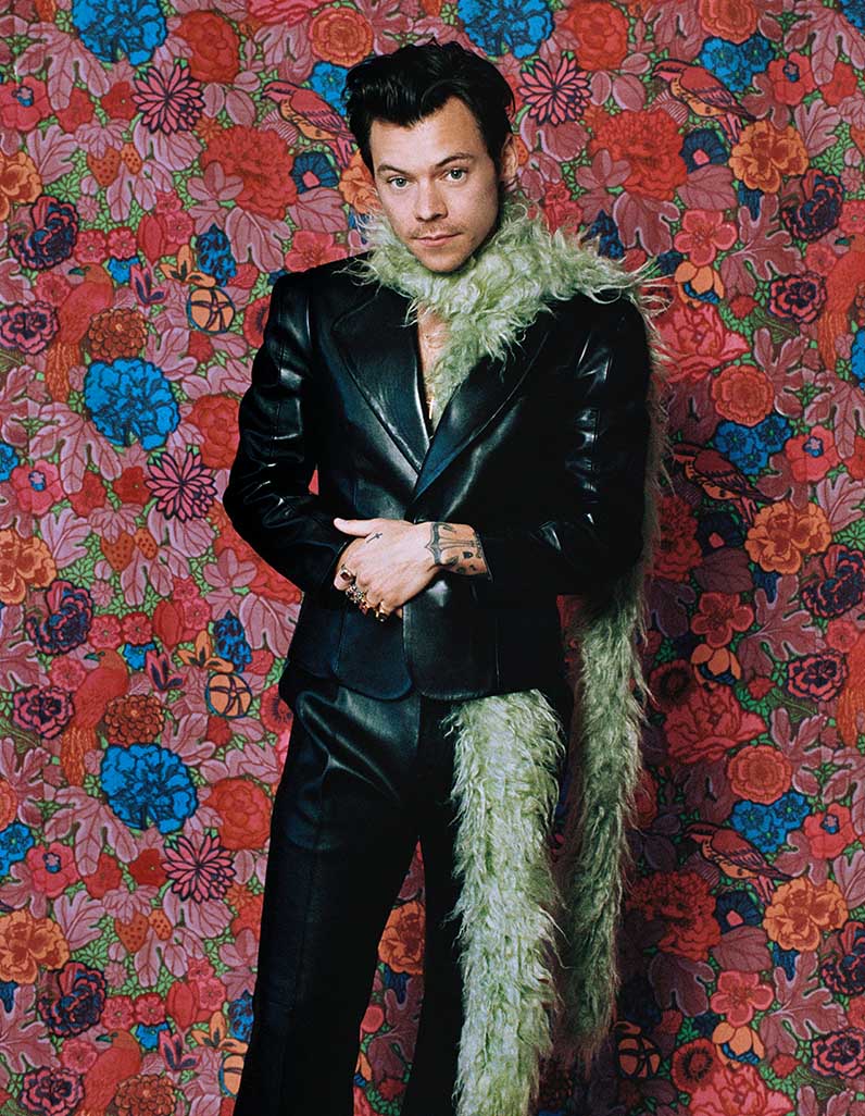 Harry Styles pairs feather boa with Gucci leather jacket and trousers