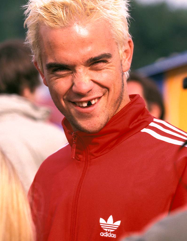 Robbie Williams in red jacket at Glastonbury 1995