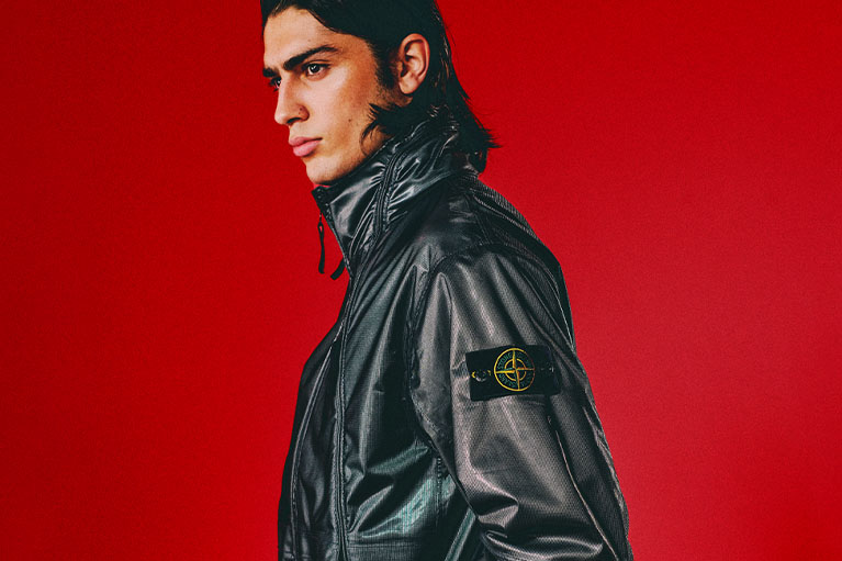 Male model wearing black Stone Island jacket 