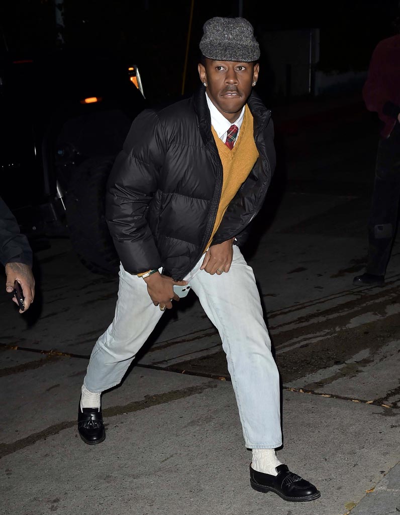Street style shot of Tyler, the Creator in an eclectic grandpa outfit