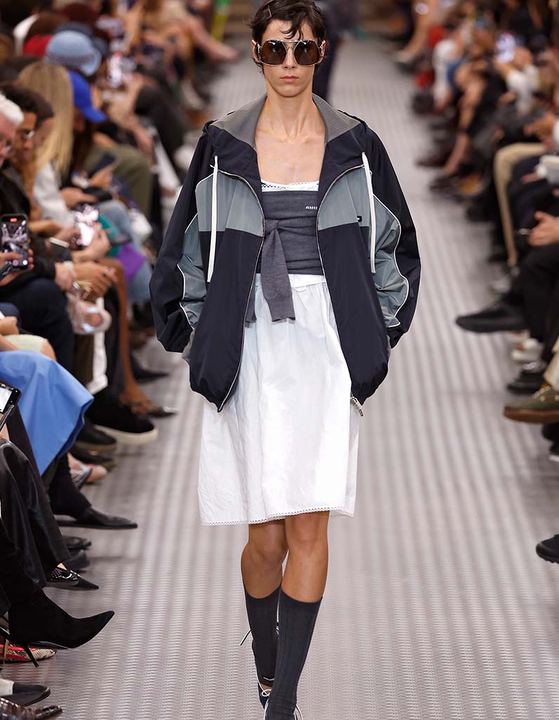 Model walks down Miu Miu runway wearing white tennis co-ord