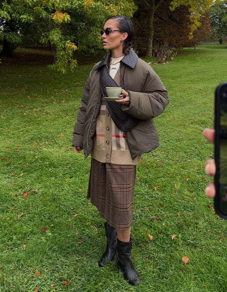 Alicia Roddy in Bottega Veneta puffer jacket, Burberry wool cardigan, Saint Laurent skirt and Chloe biker boots.