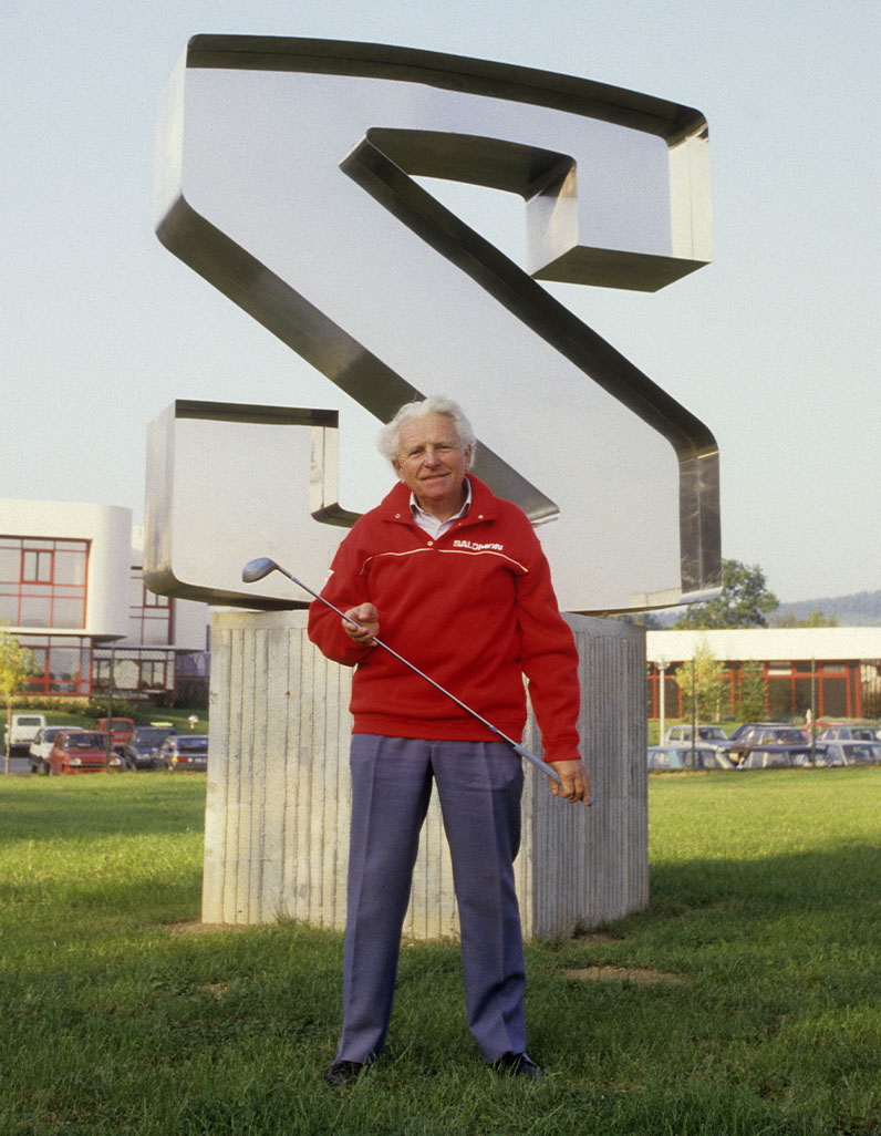 Georges Salomon infront of Salomon logo.