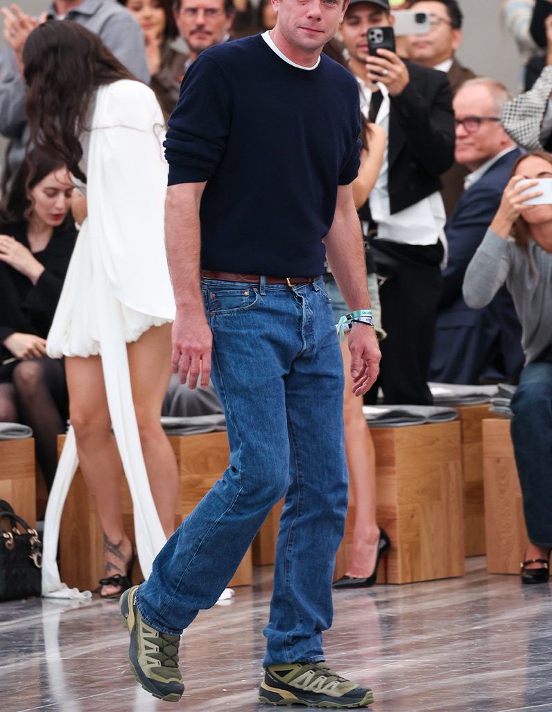 Man in black suit with a poncho sporting the Burberry Knight 