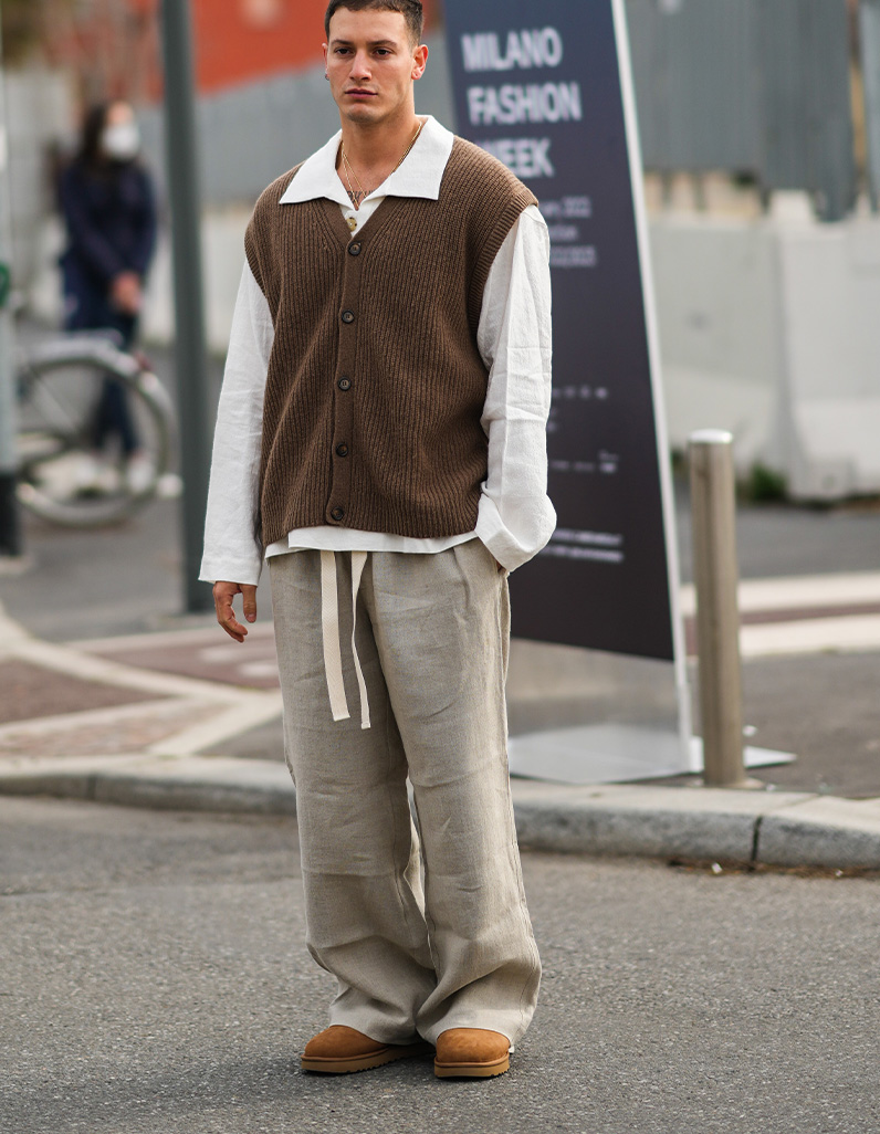 man in white cotton shirt, brow knit gilet and UGG minis 